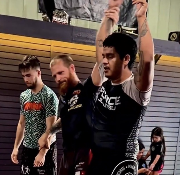 Angel Trejo having his hand raised after winning at Force Jiu-Jitsu